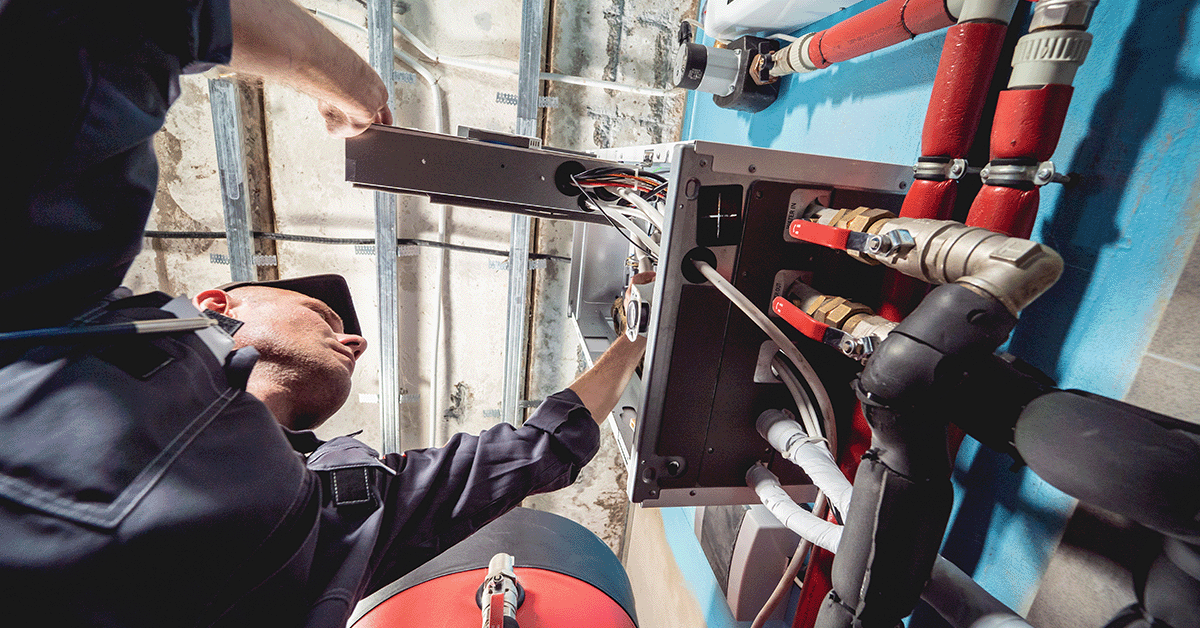 HVAC installation tech working on an air conditioning unit