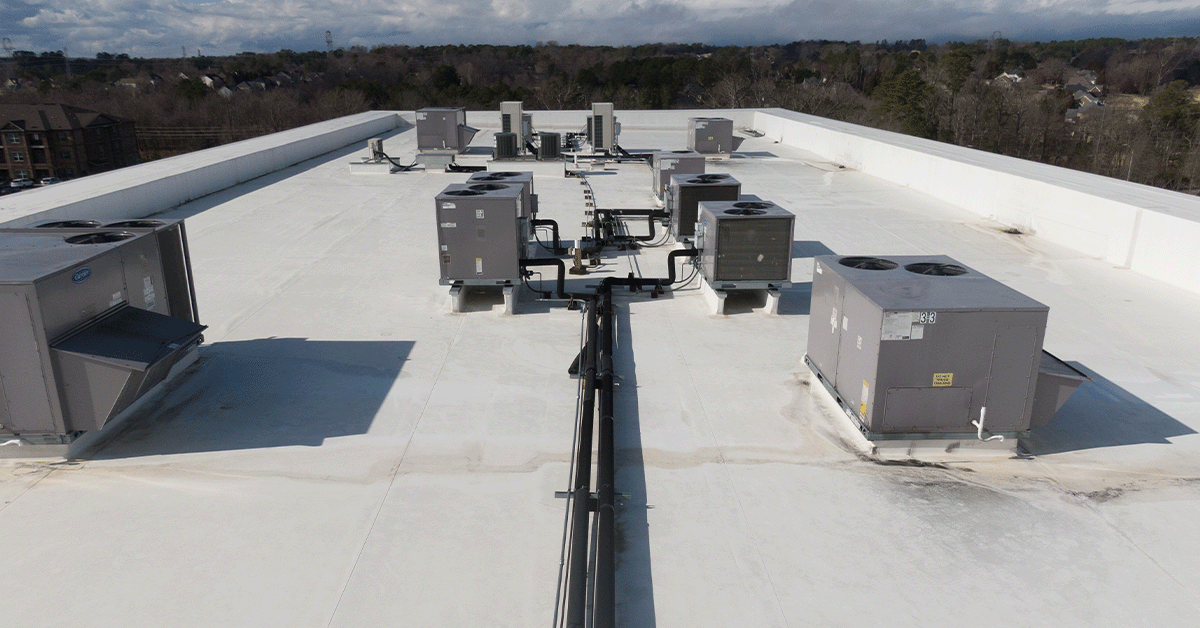 Multiple rooftop HVAC units on top of a commercial building